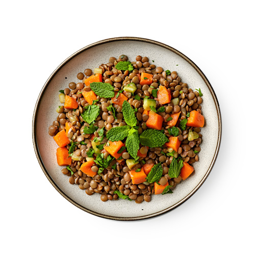 A plate of lentil salad with diced carrots, chopped herbs, and fresh mint leaves on top, served on a white dish against a white background.